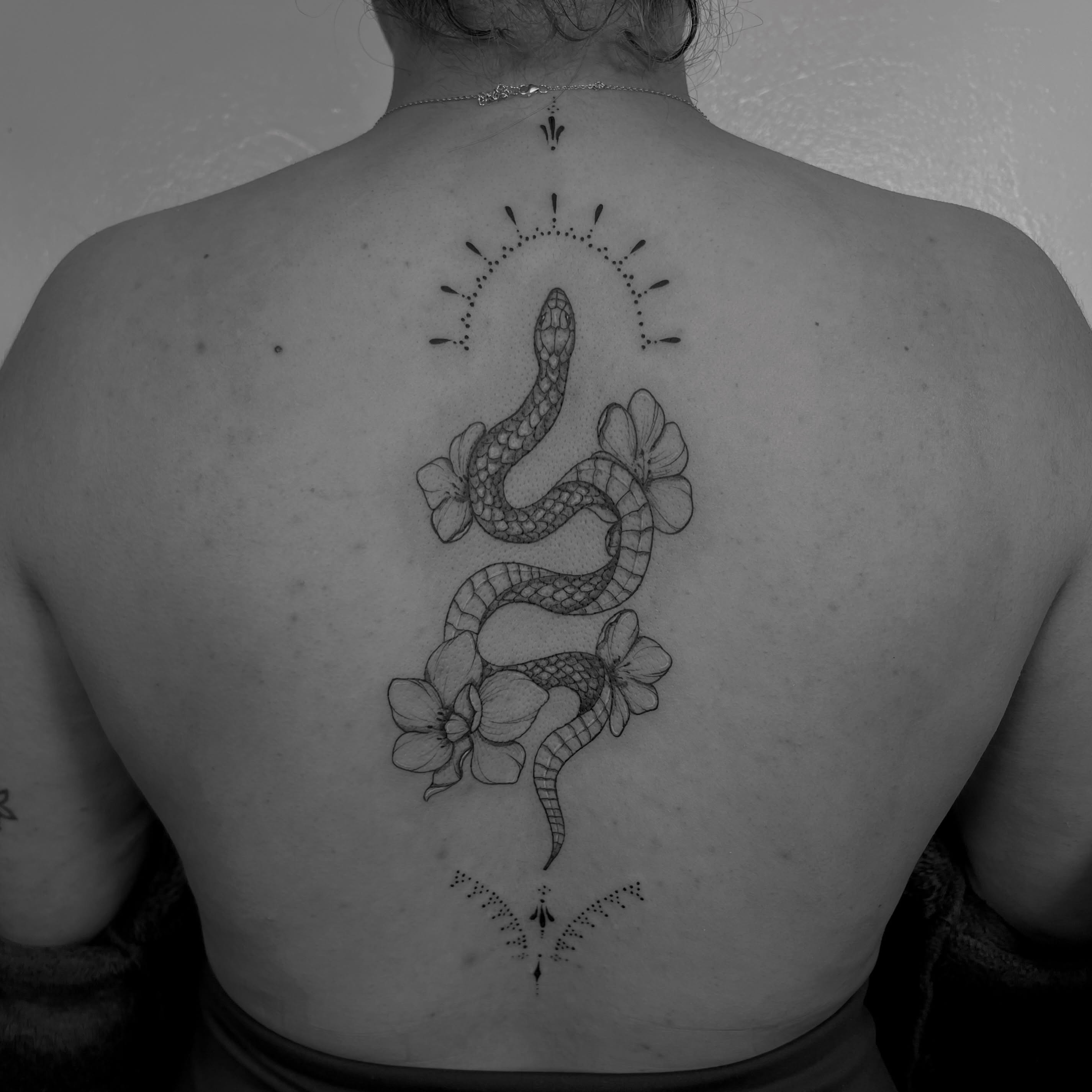 Floral snake tattoo by Clancy Murphy